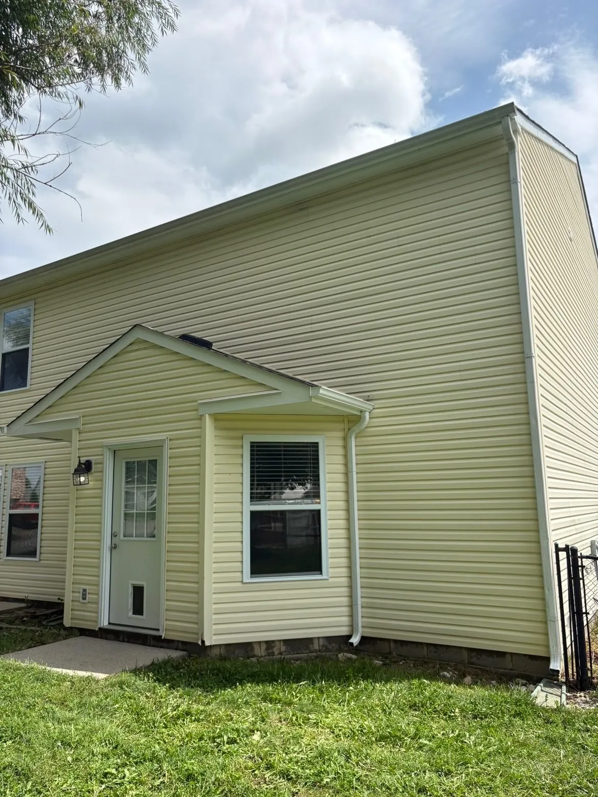 After: the same siding, soft washed.