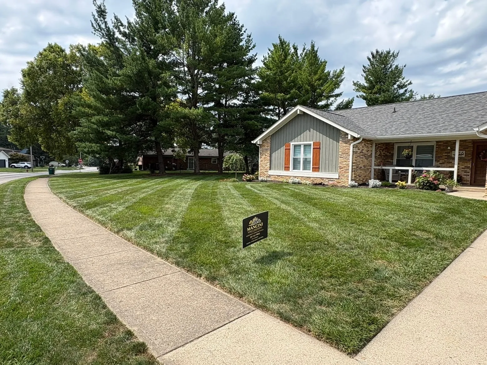 His yard sign on a front lawn mowed in stripes.